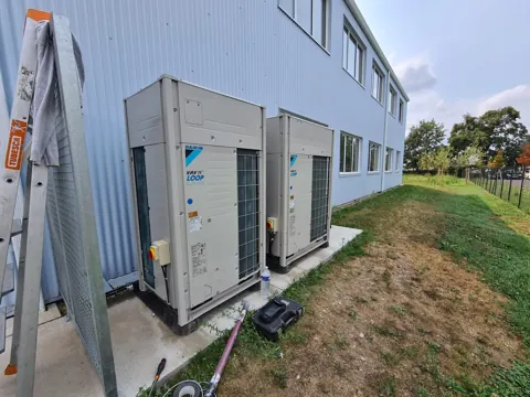 Groupes VRV Daikin au pied d'un bâtiment d'activité